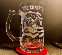 a glass mug sitting on top of a red coaster next to a black and white american flag