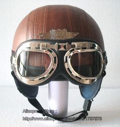 a helmet with goggles on top of it and a white wall behind the helmet