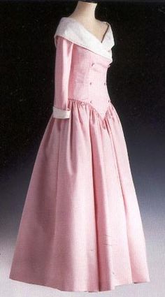 a pink dress is on display in front of a mannequin's head