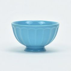 a blue bowl sitting on top of a white table