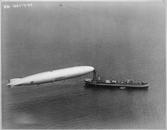 an airplane flying over a large boat in the water