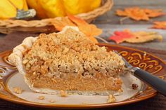 a piece of pie sitting on top of a plate next to a knife and fork