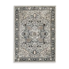 a rug with an intricate design on the front and back side, in grey tones