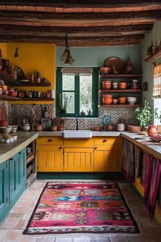 a kitchen with yellow cabinets and colorful rug