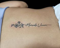 the back of a woman's stomach with a tattoo that reads, menta verance