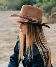 100% Wool Felt Distressed Handcrafted Ribbon Band Authentic Feather Artisian Drifter Brim Size: 3.25" Available in Sizes in S/M and L/XL Crafted from 100% wool felt, the Peter Grimm Unstoppable Cowboy Hat embodies timeless ruggedness and enduring style. Its tan hue exudes warmth, complementing any attire with effortless elegance. The distressed handcrafted ribbon band, adorned with an authentic feather, adds a touch of authenticity and character. With a brim size of 3.25 inches, this hat strikes the perfect balance between functionality and fashion, offering ample shade and protection from the elements. Available in sizes S/M and L/XL, it ensures a comfortable and tailored fit for every wearer, making it an essential accessory for any adventurer or cowboy at heart. Western Hats For Women, Felt Cowboy Hat, Cowboy Hat Bands, Felt Cowboy Hats, Western Hats, Cowgirl Hats, Effortless Elegance, Felt Hat, Country Girl