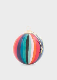 a multicolored striped ball ornament hanging from a gold - plated chain