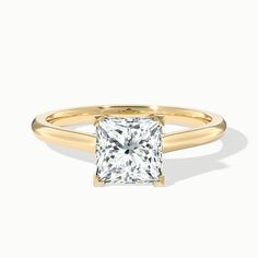 a gold ring with a princess cut diamond