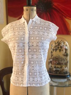 "A pretty white cotton lace blouse with shirt collar and front covered buttons. A very elegant blouse.  I don't know the name of this lace but it appears to be a very fine crochet. In excellent condition. Handmade  Size Medium  Bust 36\" Waist 29\" Length 20\"" Elegant Cotton Lace Top With Lace Collar, White Lace Collar Top With Short Sleeves, White Broderie Anglaise Lace Top With Short Sleeves, Summer Collared Lace Blouse, Collared Lace Blouse For Summer, Collared Lace Blouse With Lace Top, Fitted Collared Lace Tops, Summer Lace Blouse With Collar, Elegant White Lace Top With Broderie Anglaise