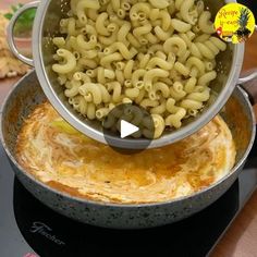 a pan filled with macaroni and cheese on top of a stove