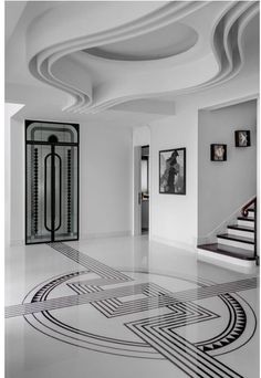 a white room with black and white designs on the floor