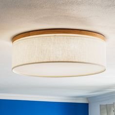 a light fixture hanging from the ceiling in a room with blue walls and white carpet