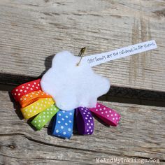 a keychain with some colorful hair clips attached to it's side on a wooden surface