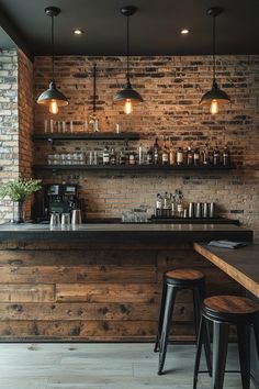 a bar with stools in front of it and lights above the bar top on brick walls