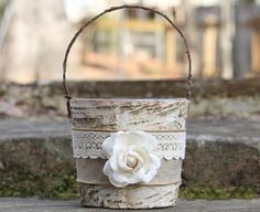 a white flower sitting in a wooden basket