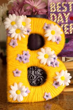 the letter b is decorated with daisies and flowers