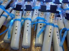 snowmen are wrapped in plastic and tied with blue ribbon