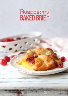 raspberry pastries on a white plate with fresh raspberries