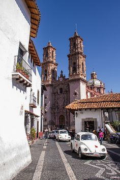 cars are parked in front of an old church