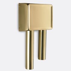 a gold door handle on the side of a white wall with a square shaped object attached to it