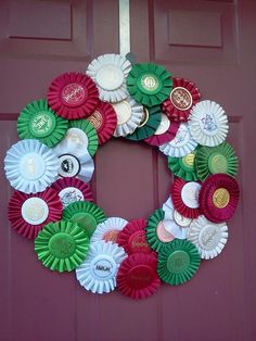 a wreath made out of bottle caps on the front door is decorated with red, green and white ribbons