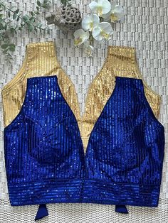 Dark Blue or Gold color Sequins Sleeveless Saree Blouse/choli.   Available in Bust Size 34, 36, 38, 40. Measure around fullest part of bust & Choose Size from Options. Blouse is Padded, with Back Opening and Ties & Tassels. Get ready in style with this trendy bollywood celebrity style deep neckline designer blouses in Sabyasachi inspired design. Versatile Blouse to go with any party wear sarees, georgette saris, chiffon sarees, silk sarees, organza sarees & lehenga.  *Slight colour variation is Indian Crop Tops, Sleeveless Saree Blouse, Sleeveless Saree, Top Lehenga, Sleeveless Blouse Saree, Golden Blouse, Lehenga Crop Top, Sequence Blouse, Crop Top Lehenga