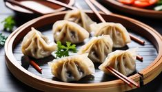 some dumplings are sitting on a plate with chopsticks