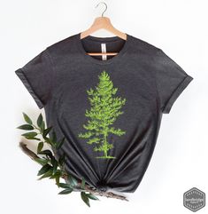 "Skinny Pine Trees T-Shirt, Pine Tree Shirt, Tree Graphic Tee, Nature Shirt, Forest Graphic Tee - Unisex Style and color shown on main image: (Unisex Dark Grey Heather) All T-Shirt apparel are printed using direct-to-garment (also known as DTG). In addition, our inks are water based and eco-friendly. This makes the feel much softer than traditional screen printed shirts, but just as durable. **All sales are final and we don't accept returns. If we made a mistake we will send a replacement.** The Green Graphic Tee With Crew Neck, Tri-blend Pre-shrunk Graphic Tee, Green Crew Neck Top With Screen Print, Tri-blend Graphic Tee With Screen Print, Green Graphic Tee With Screen Print, Green Crew Neck Shirt, Tri-blend Crew Neck Graphic Tee, Forest Graphic, Tree Graphic