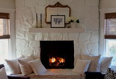 a living room filled with furniture and a fire place in the middle of the room