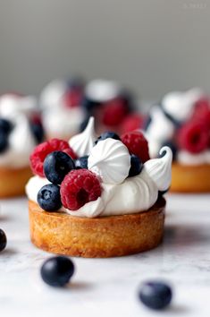 small desserts with berries and whipped cream on top