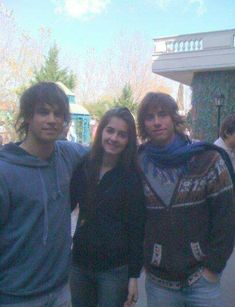 three young people standing next to each other