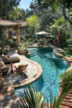 an outdoor swimming pool surrounded by greenery