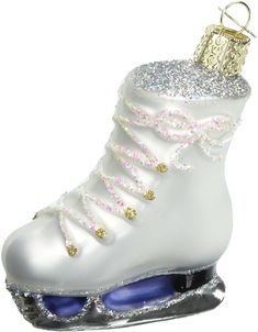 a white ornament with a roller skate on it's side and gold accents