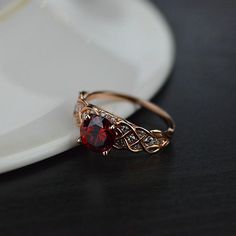 This one of a kind ring features beautiful lattice design which embeds gorgeous jewels of your choice and elegantly twists into the main center stone. The default design option features 2 Carat Round 8mm Created AAAAA -Grade RubyEngagement Ring with 24 Natural 0.2 CTW Diamond (HI I2) Accent Stones 14K Rose Gold Ring. As well please remember it takes up to 14 days to make and ship this item. Please remember that you can customize this ring in any way you would like in 3D. Ruby Ring Designs, King Of Wrath, Ruby Wedding Rings, Red Stone Ring, Ruby Wedding, Gold Ring Designs, Lattice Design, Ruby Engagement Ring, Dream Engagement Rings