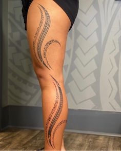 a woman's legs with an intricate tattoo on the lower part of her leg