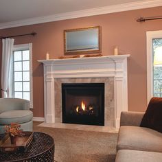 a living room filled with furniture and a fire place in the middle of the room