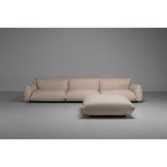 a large sectional sofa with ottoman and footstool in beige fabric, on a grey background