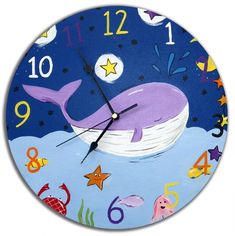 a clock with an image of a whale in the water and stars on it's face