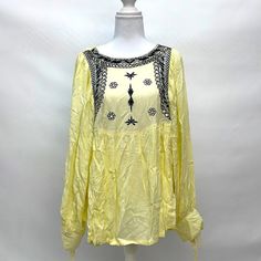 This Ananda S. Yellow Tunic Is A Summer Staple. It Features A Front Navy Embroidered Design With Gold Sequence. The Sleeves Have A Tie Detail. This 100-% Rayon Tunic Has An Open Back With A Buckle Detail Across. Hand Wash Only. Yellow Long Sleeve Tops With Floral Embroidery, Yellow Embroidered Beach Top, Yellow Embroidered Top For Beach, Yellow Long Sleeve Blouse With Floral Embroidery, Yellow Bohemian Tops With Floral Embroidery, Bohemian Yellow Tops With Floral Embroidery, Spring Yellow Top With Floral Embroidery, Yellow Floral Embroidered Top For Spring, Yellow Casual Festival Blouse