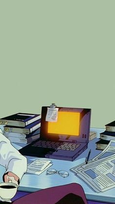 a man sitting in front of a laptop computer on top of a desk next to a pile of books