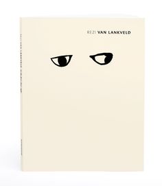 a white book with black eyes on it