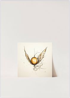 a card with an image of a golden ball and wings on the front, against a white background