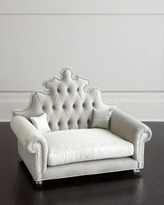 a white chair sitting on top of a wooden floor