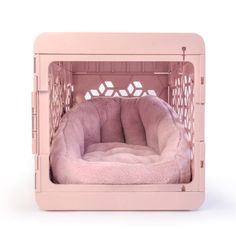 a pink dog bed in the shape of a cage with a fur lining on it