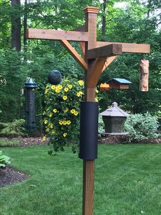 a wooden cross with birds on it in the yard