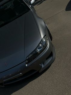 a silver sports car parked in front of a building