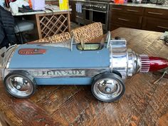 a toy car is sitting on the floor in front of a table with other furniture