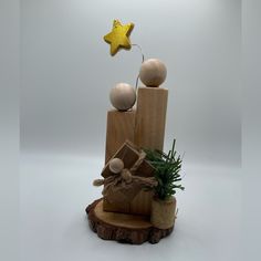 a small wooden star on top of a tree stump with other wood items around it