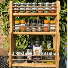 a wooden spice rack filled with lots of different types of spices and condiments