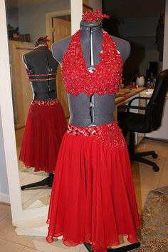 two mannequins dressed in red and grey dresses